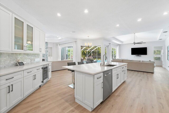 kitchen featuring white cabinets, a wealth of natural light, sink, and dishwasher