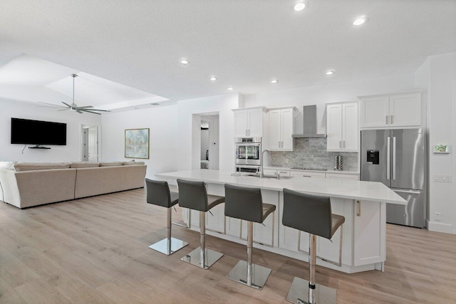 kitchen featuring white cabinetry, stainless steel appliances, and a breakfast bar