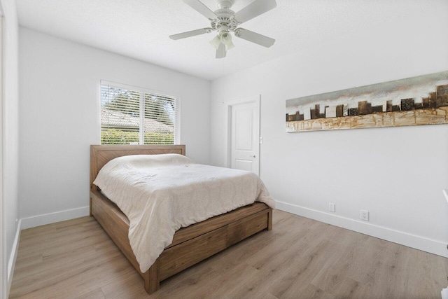 bedroom featuring light hardwood / wood-style floors and ceiling fan