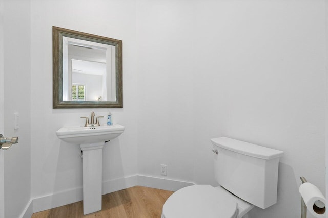 bathroom featuring hardwood / wood-style flooring and toilet