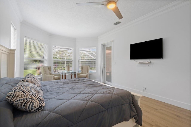 bedroom with crown molding, wood-type flooring, ceiling fan, and a textured ceiling