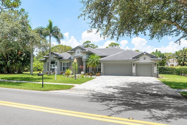 single story home featuring a front lawn and a garage