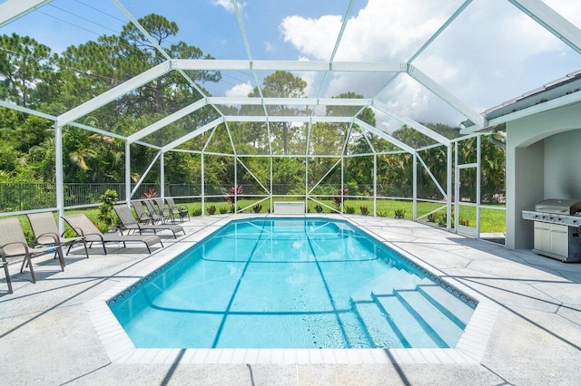 view of swimming pool featuring a patio area, area for grilling, and a lanai