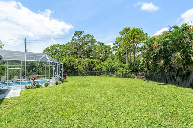 view of yard featuring a fenced in pool and a lanai