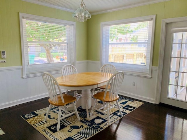 dining space with crown molding, dark hardwood / wood-style floors, and a healthy amount of sunlight