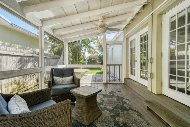 sunroom featuring wood ceiling, beam ceiling, and ceiling fan