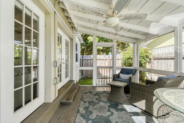 sunroom featuring beam ceiling