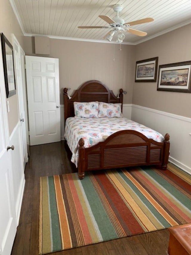 bedroom featuring dark hardwood / wood-style flooring, ornamental molding, wood ceiling, and ceiling fan