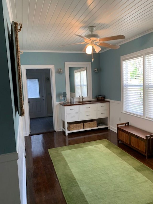 bedroom with crown molding, dark wood-type flooring, wood ceiling, and ceiling fan