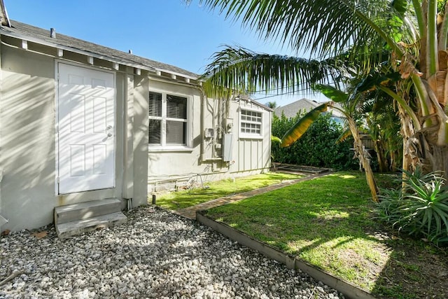 view of side of home with a yard