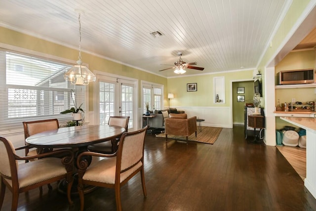 dining space featuring ceiling fan with notable chandelier, ornamental molding, wood ceiling, dark wood-type flooring, and french doors