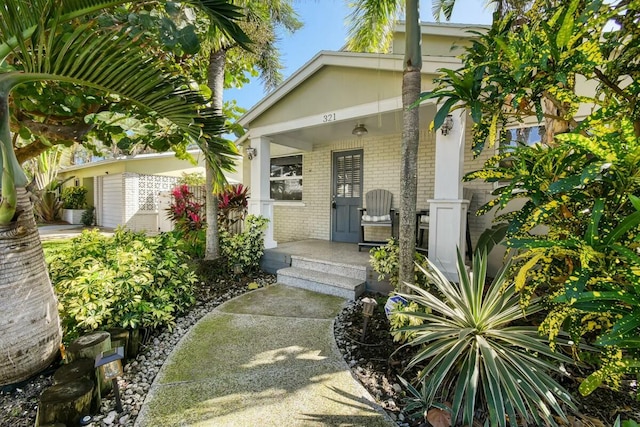 view of exterior entry with a porch