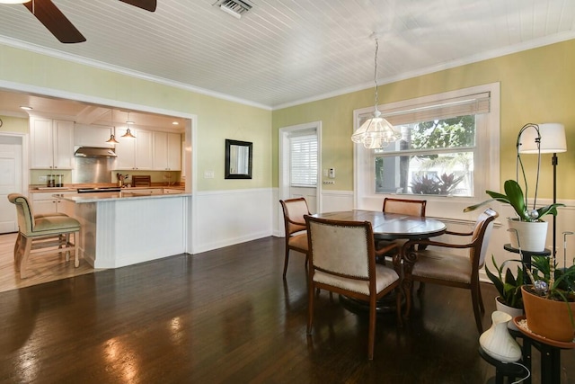 dining space featuring crown molding, ceiling fan, and dark hardwood / wood-style flooring