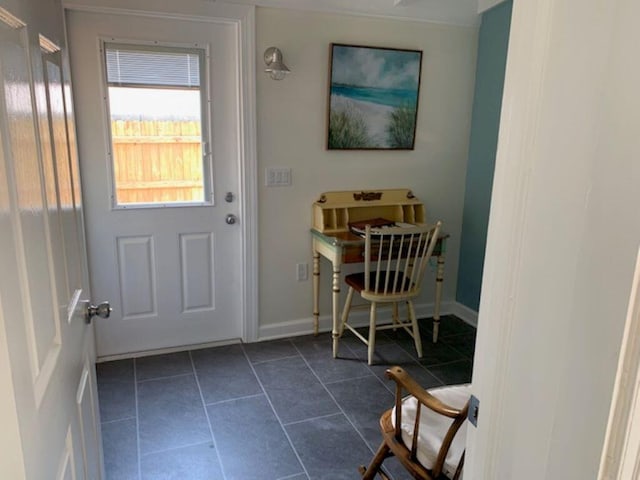 entryway featuring dark tile patterned floors