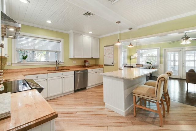 kitchen with white cabinetry, dishwasher, sink, and hanging light fixtures