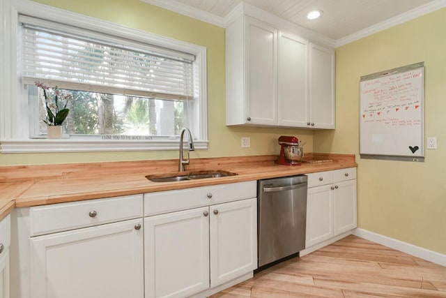 kitchen with white cabinetry, wooden counters, dishwasher, and sink