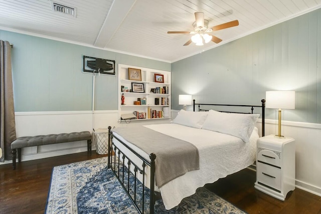 bedroom featuring ceiling fan, ornamental molding, and dark hardwood / wood-style floors