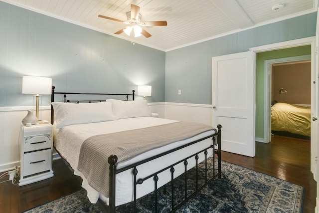 bedroom featuring crown molding, dark hardwood / wood-style floors, wooden ceiling, and ceiling fan