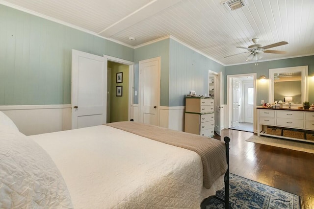 bedroom with wood ceiling, hardwood / wood-style flooring, ensuite bath, and ornamental molding