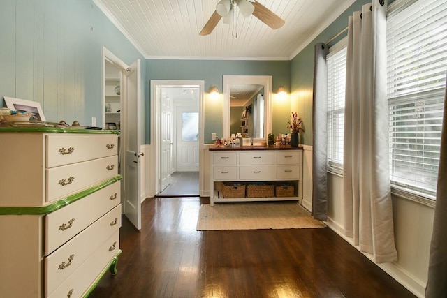 interior space with dark hardwood / wood-style flooring, crown molding, and multiple windows