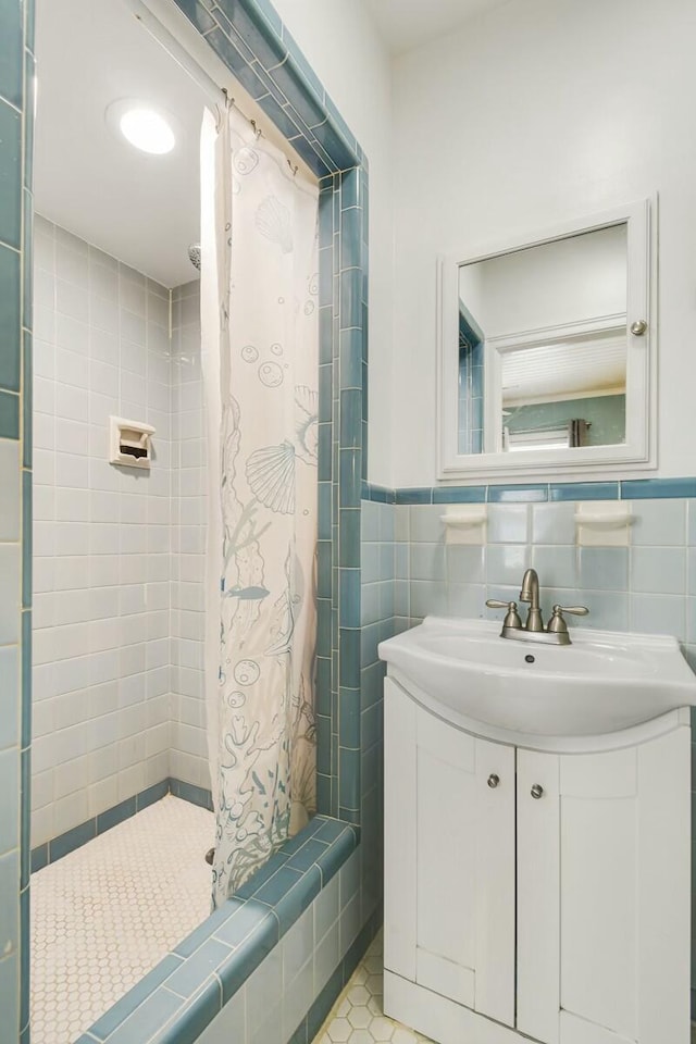 bathroom with tile walls, vanity, tile patterned floors, and a shower with shower curtain