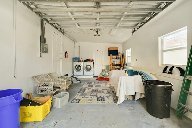 garage with a garage door opener and washing machine and dryer