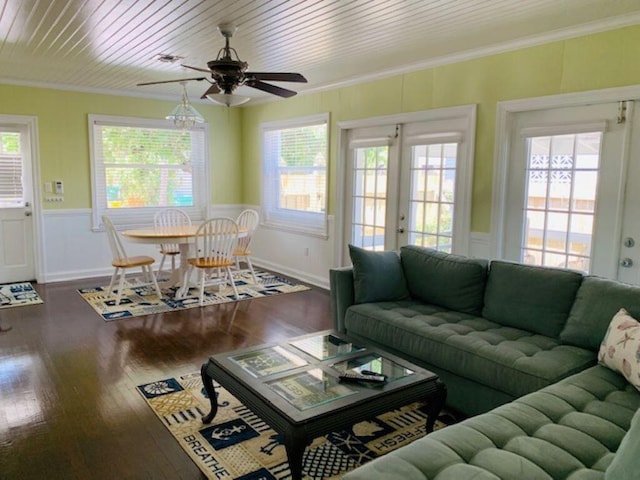 living room featuring crown molding, a healthy amount of sunlight, and dark hardwood / wood-style flooring