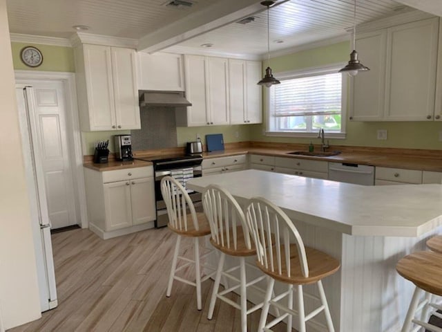 kitchen with white appliances, sink, pendant lighting, and white cabinets