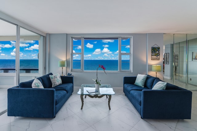 living room featuring a wealth of natural light and a water view