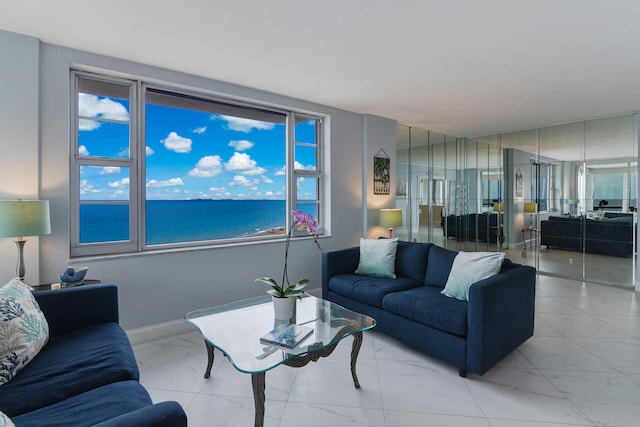 living room featuring a water view and plenty of natural light