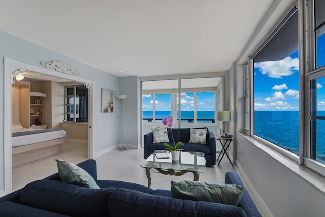 living room with a water view and ceiling fan