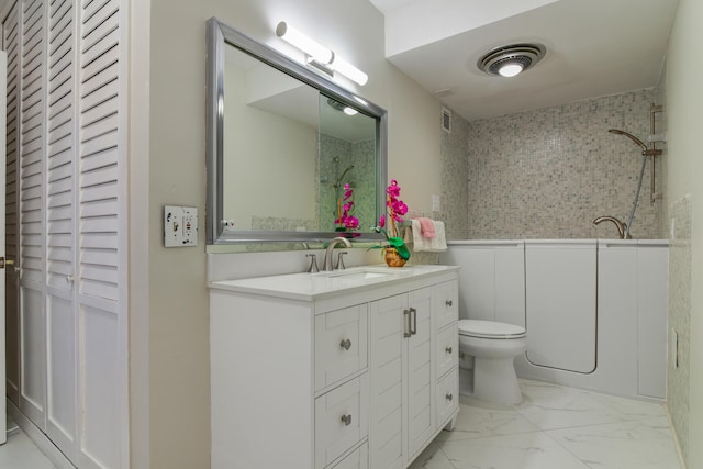 full bathroom with toilet, tiled shower / bath combo, and vanity