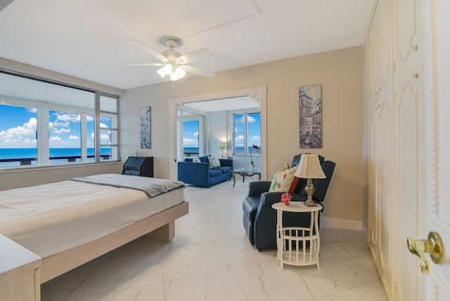 bedroom with a water view and ceiling fan