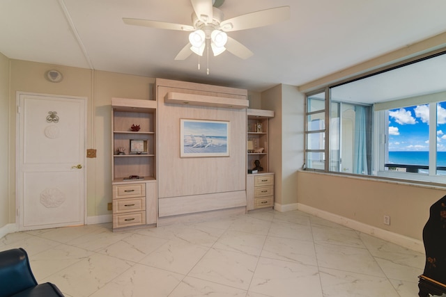 interior space with ceiling fan