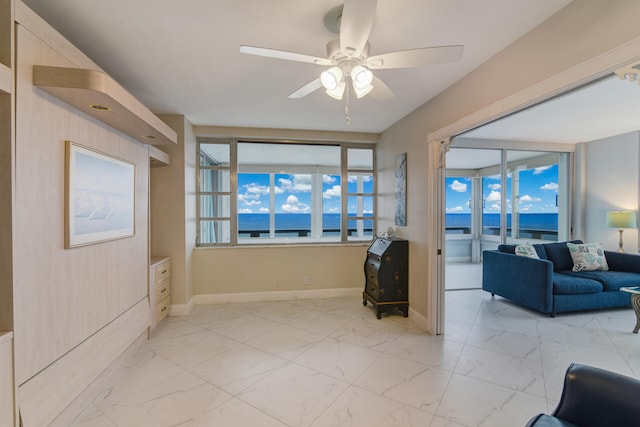 living room featuring a water view and ceiling fan