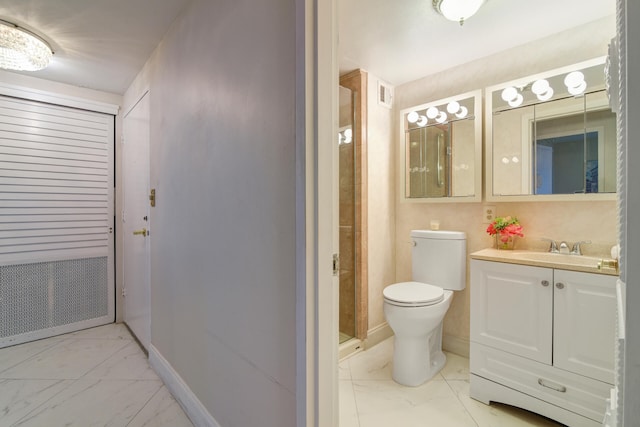 bathroom featuring vanity, toilet, and walk in shower