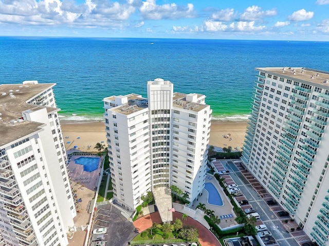 bird's eye view featuring a water view and a beach view