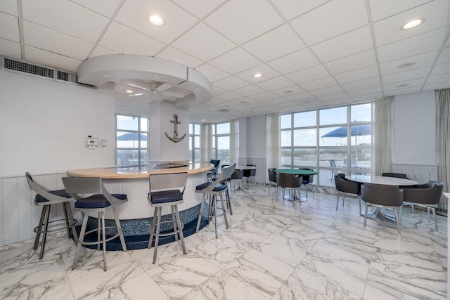 kitchen with a drop ceiling and a breakfast bar area