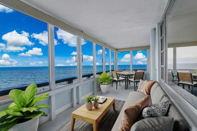 sunroom / solarium featuring a water view