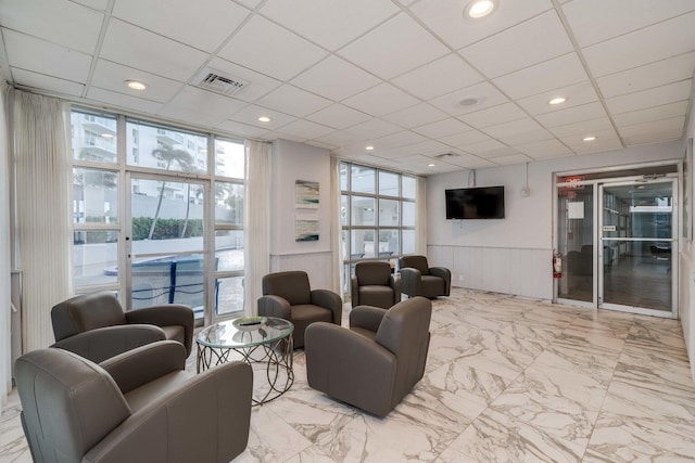 living room featuring a drop ceiling