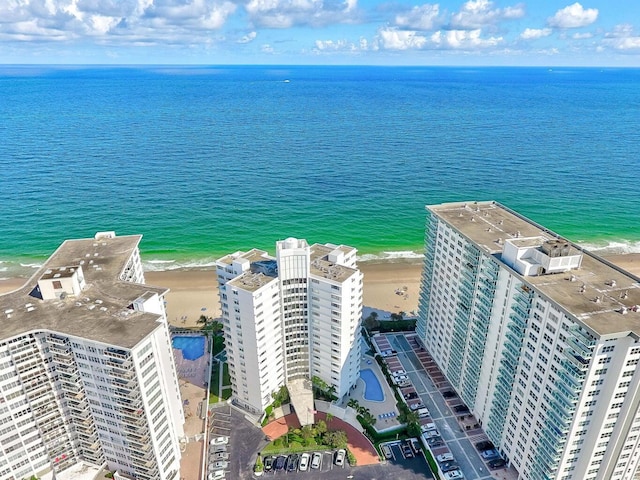 bird's eye view featuring a water view and a beach view