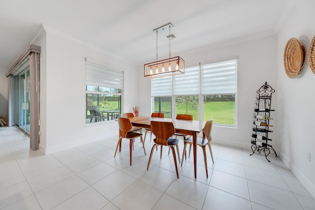 dining area with a notable chandelier, light tile patterned floors, and crown molding