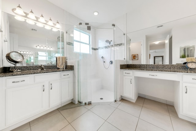 bathroom featuring vanity, tile patterned floors, and an enclosed shower