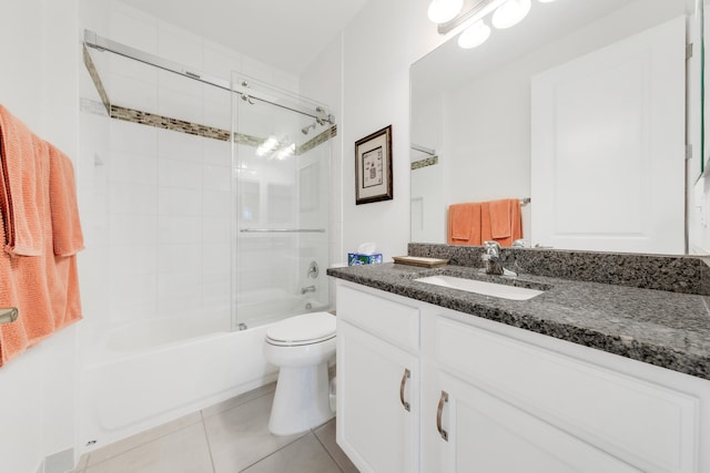 full bathroom with toilet, vanity, bath / shower combo with glass door, and tile patterned floors