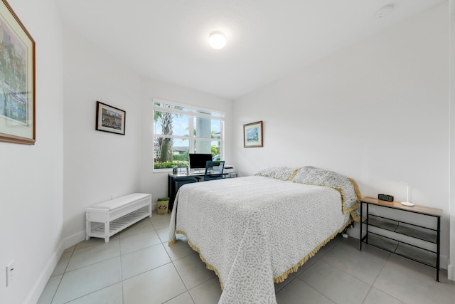 bedroom featuring vaulted ceiling and tile patterned flooring