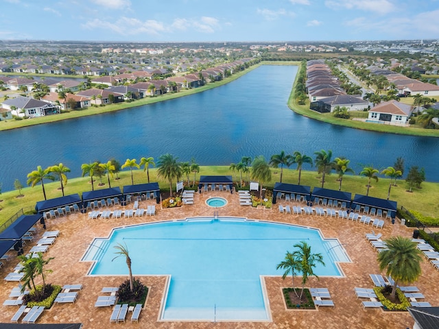 view of pool with a patio area and a water view