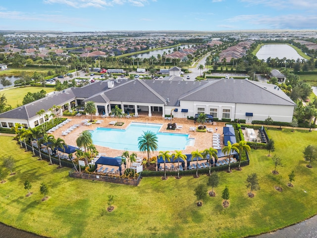 view of swimming pool with a water view, a patio, and a yard