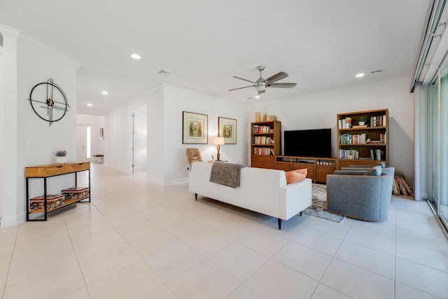 tiled living room with ornamental molding and ceiling fan