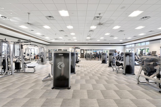 gym with light carpet and a drop ceiling