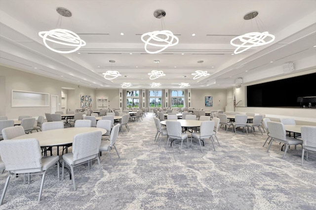 carpeted dining space with a raised ceiling and a notable chandelier